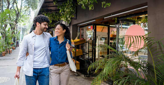 a man and woman walking down a sidewalk outside a store at Allure at Edinburgh, Chesapeake, VA, 23322