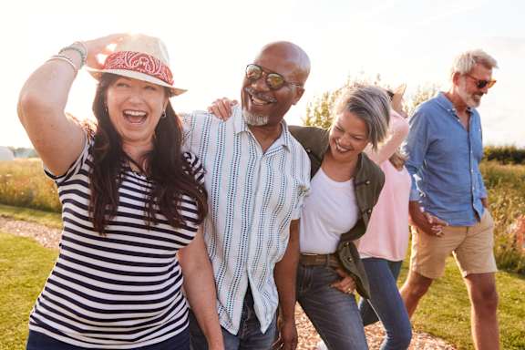 A group of people are walking together in a field.