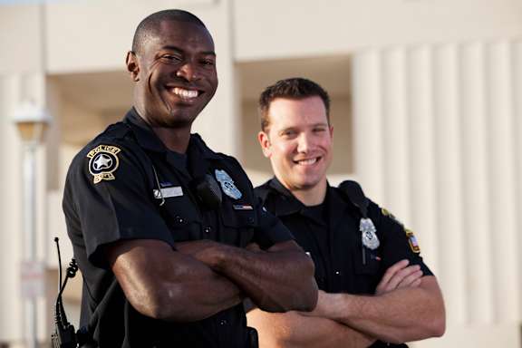 Two police officers standing with their arms crossed.