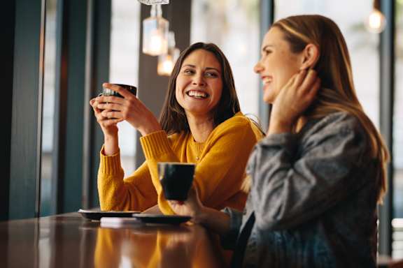 Two women are sitting at Sugarloaf Crossing Apartments, Georgia