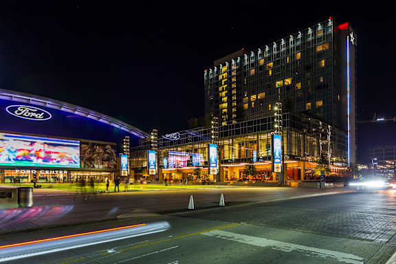 A Ford dealership is lit up at night.