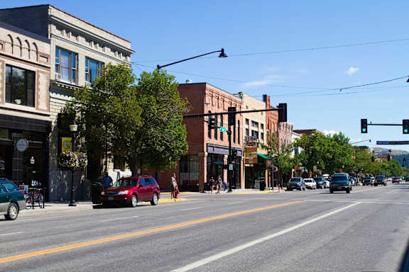 A street view of a town with cars and buildings.