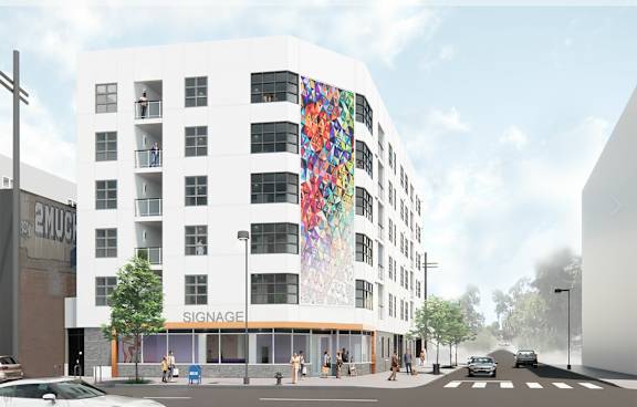 A white building with a colorful mural on the side.