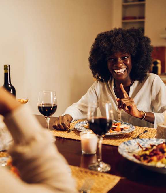 A man and a woman are preparing food together in a kitchen.