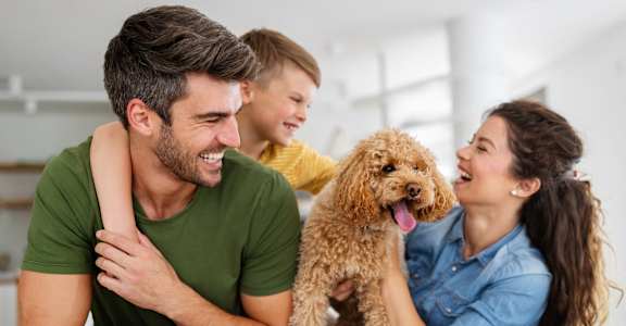 a group of people with a dog on a couch at Allure at Edinburgh, Virginia, 23322