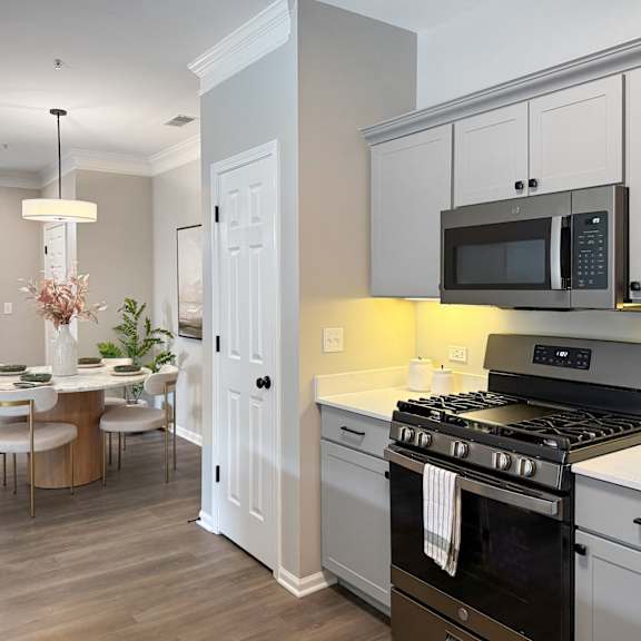 A kitchen with a black microwave above the stove.