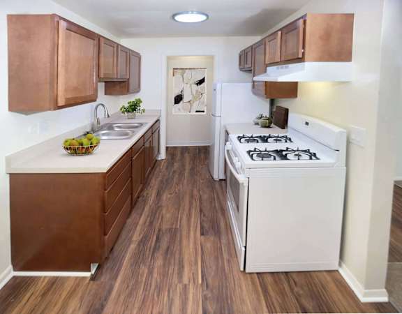 a kitchen with white appliances and wooden cabinets
