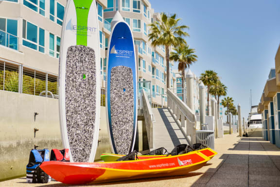 a row of surfboards standing in front of a building at Esprit Apartments, Marina del Rey, CA