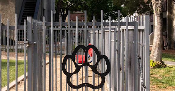 a gate with a olympic symbol on it in front of a fence