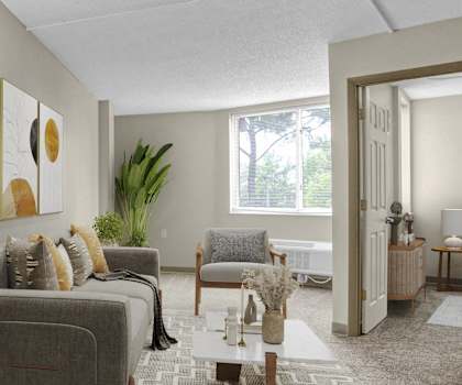 the living room of an apartment with two chairs and a couch