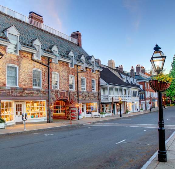 a city street with brick buildings and a street lamp