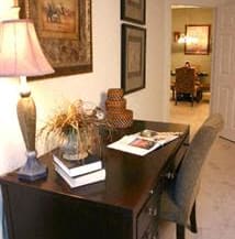 a desk with a lamp and a book on it at The Sanctuary of Lake Villa, Lake Villa, IL