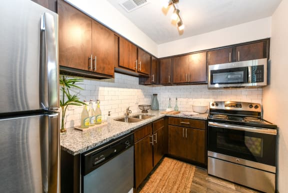 the kitchen at the enclave at woodbridge apartments in sugar land, tx