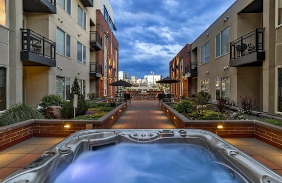  A pool in the middle of a courtyard surrounded by buildings.