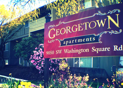 a sign in front of a building that says georgetown apartments
