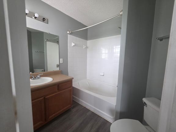 A bathroom with a sink, toilet, and bathtub.