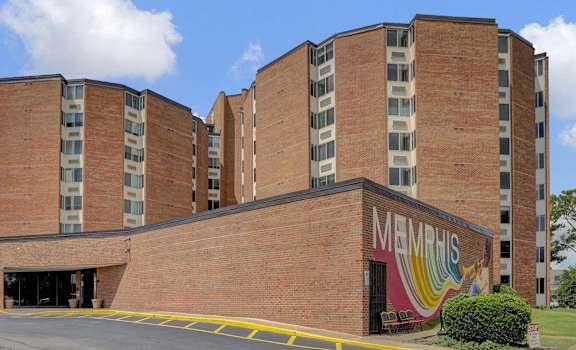 a large brick building with a mural on the side of it