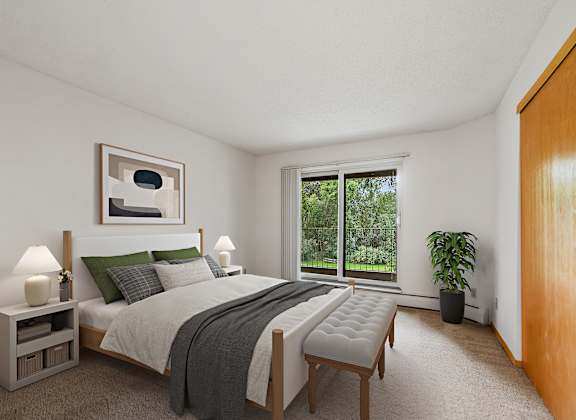 a bedroom with a bed and a large window
