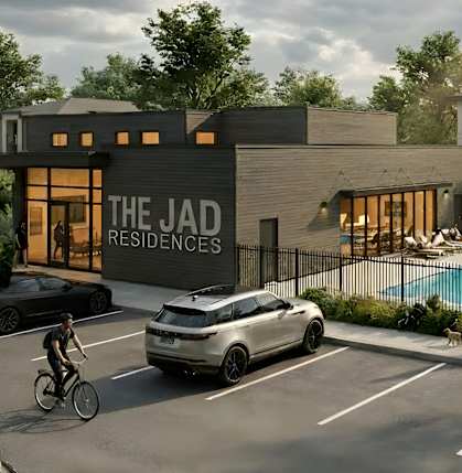 The Jad Residences is a modern apartment complex with a pool and electric vehicles parked in front.