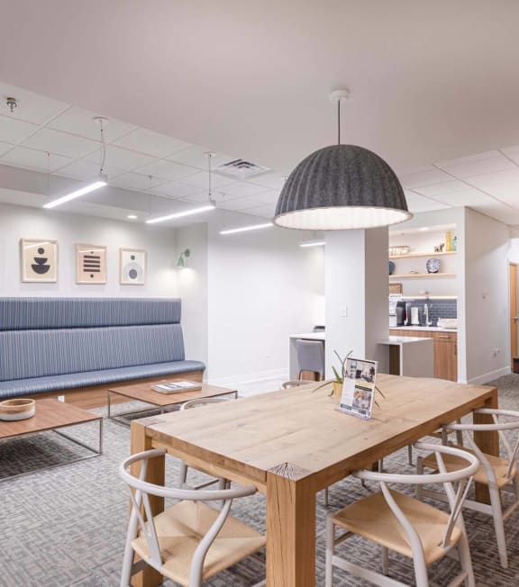 a conference room with a table and chairs and a blue couch