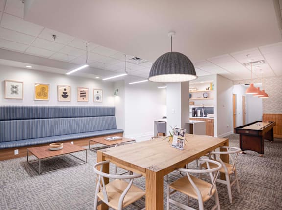 a conference room with a table and chairs and a blue couch