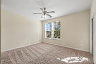 A room with a ceiling fan and a window.