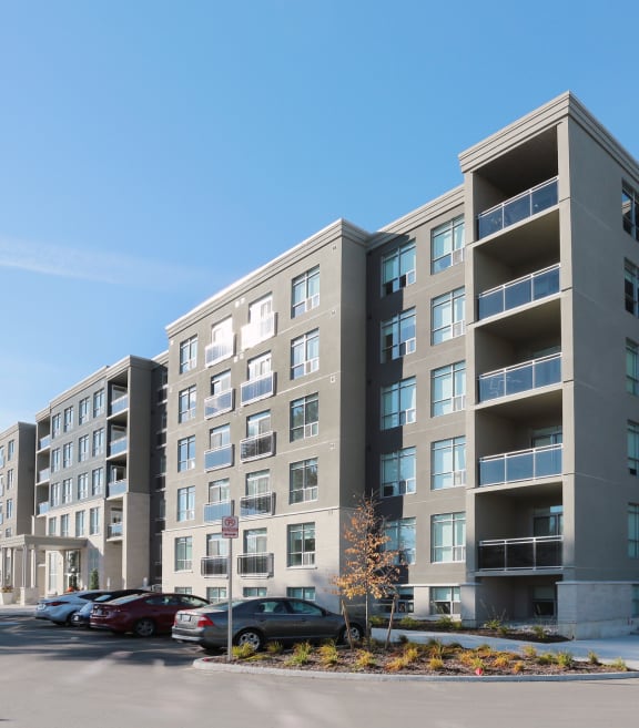 a large apartment building with a parking lot in front of it