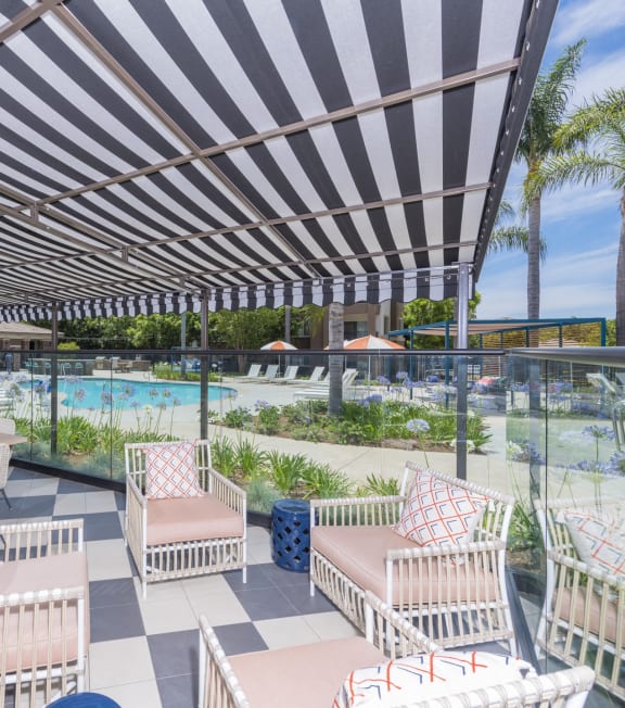 a patio with chairs and tables and a swimming pool