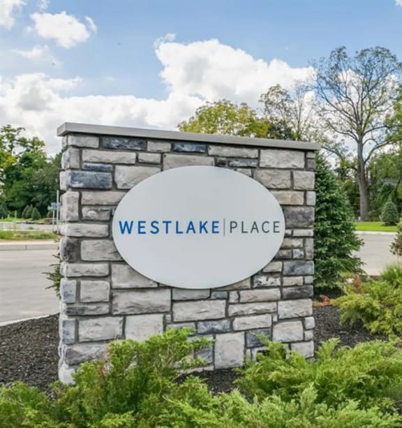 a stone monument with a sign that reads westlake place