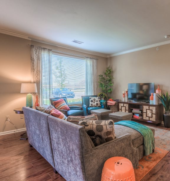 a living room with a couch and a tv at WaterCrest at City Center, Kansas, 66219