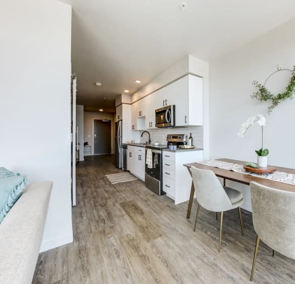 a dining room and kitchen with a table and chairs