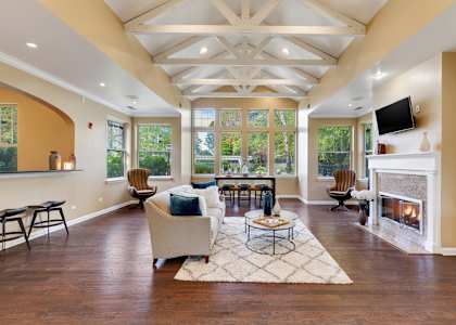 a large living room with a fireplace and a tv