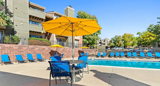 Swimming pool and sundeck loungers at Silver Reef Apartment Homes in Lakewood, CO