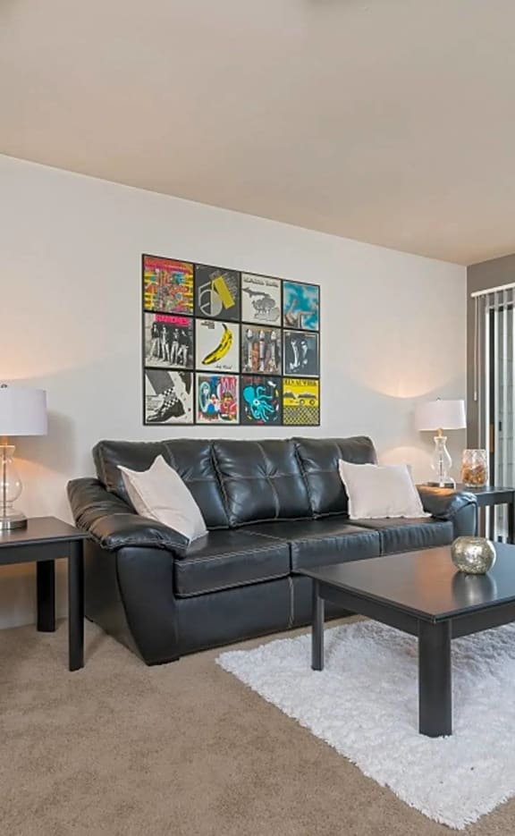 a living room with leather furniture and a sliding glass door