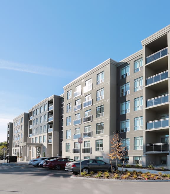 a large apartment building with a parking lot in front of it