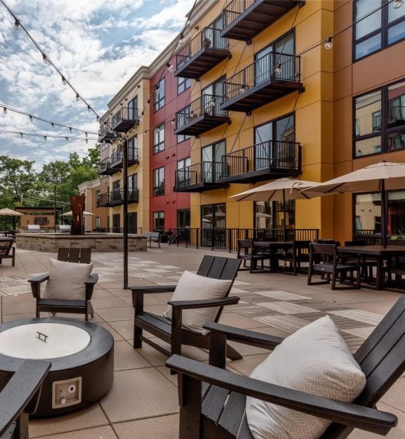 a patio with chairs and tables in a courtyard