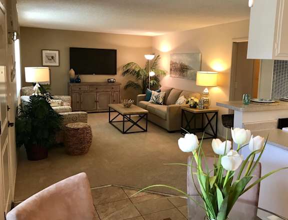 a living room filled with furniture and a flat screen tv