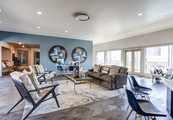 a living room with blue walls and a couch and chairs