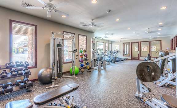 a fitness room with weights and other exercise equipment at the enclave at woodbury at WaterCrest at City Center, Lenexa, KS, 66219