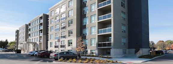 a large apartment building with a parking lot in front of it