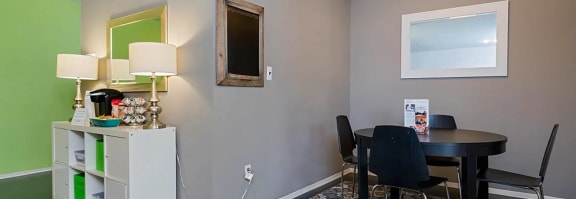 a dining room with a table and chairs and a window