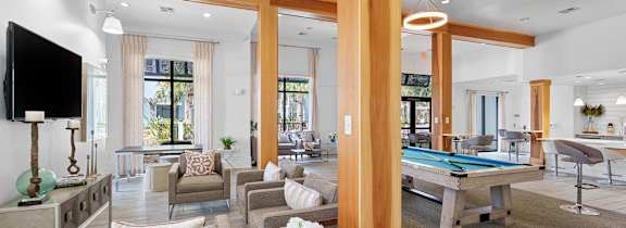 A blue couch is on a wooden deck with a railing.