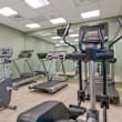 A gym with treadmills, exercise bikes, and weight machines.