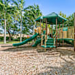 A playground with a blue slide and wooden structure.