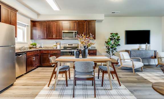A modern kitchen with a dining table set for four.