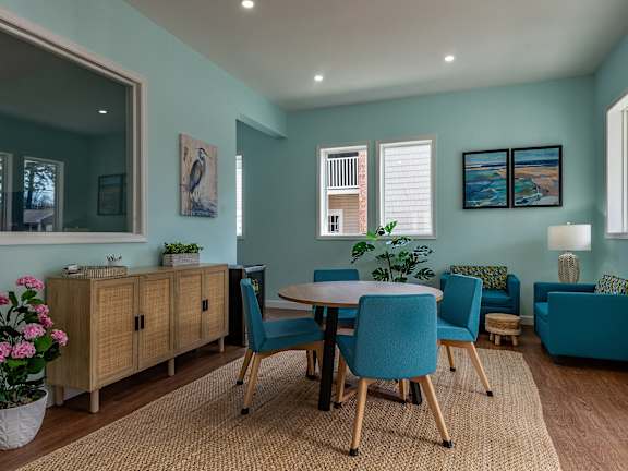 A dining room with a table set for four.
