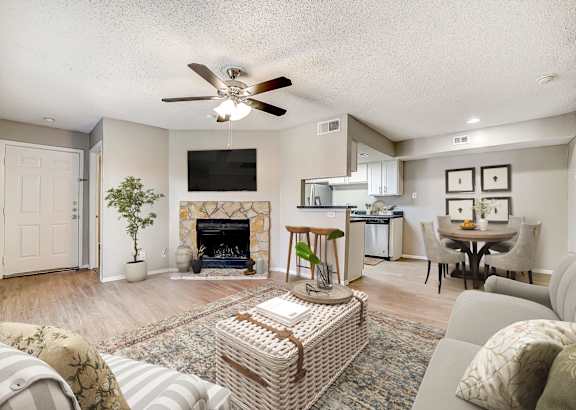 A living room with a fireplace and a television.
