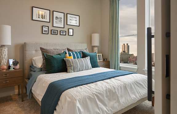 a bedroom with a bed and a window at Link Apartments® Canvas, Atlanta, GA, 30312