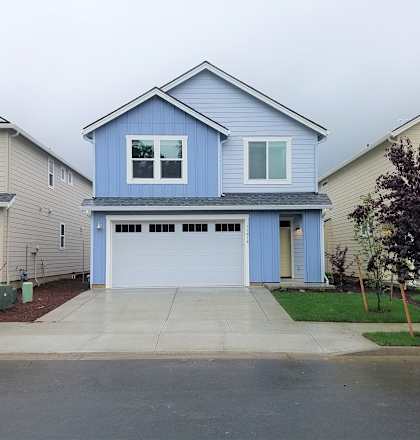 A blue house with a white garage door.