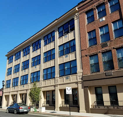 a view of a tall building with blue sky above it